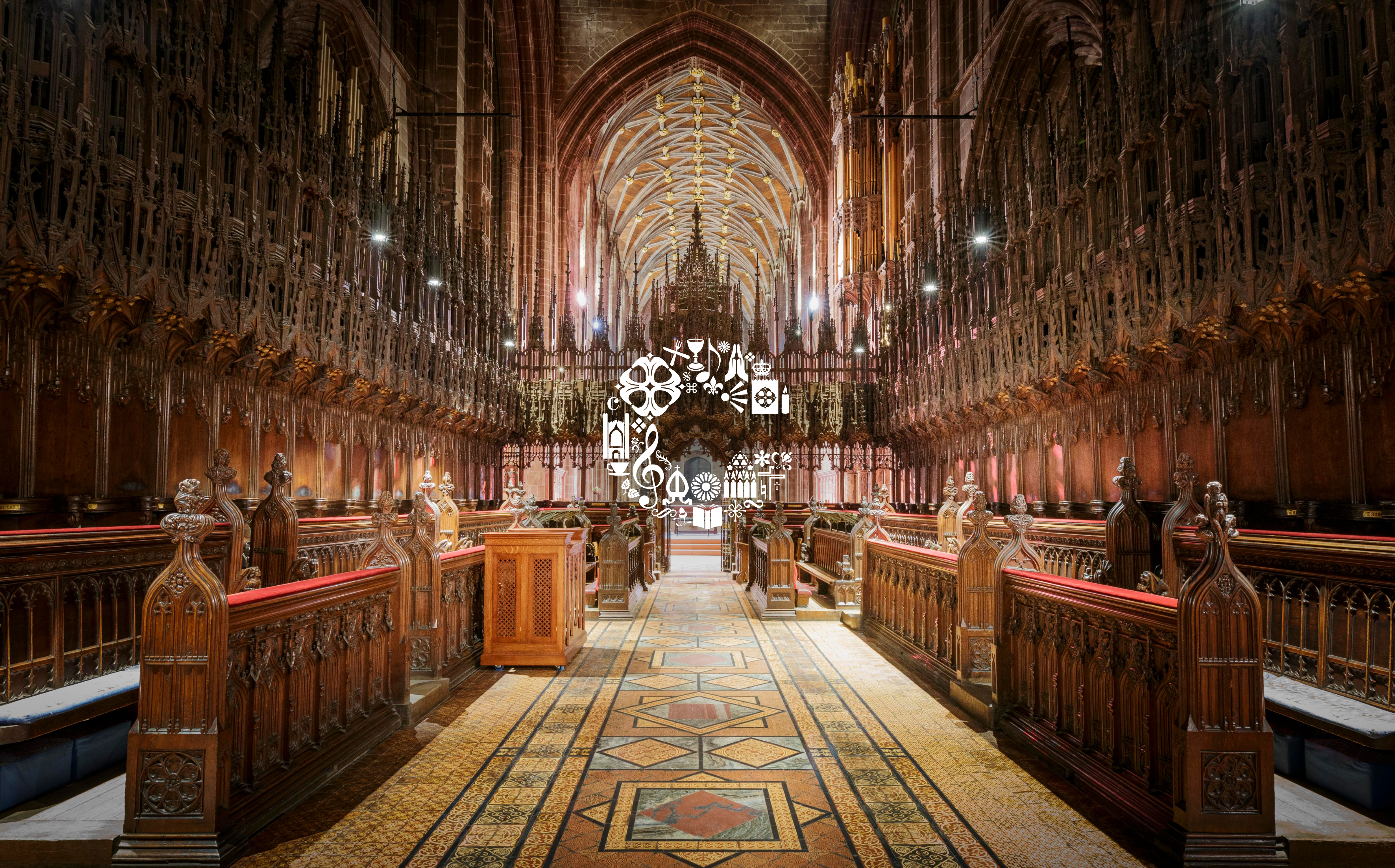 Ornate church choir with carved wooden stalls and tiled aisle under a vaulted ceiling, warm lighting and a white icon.
