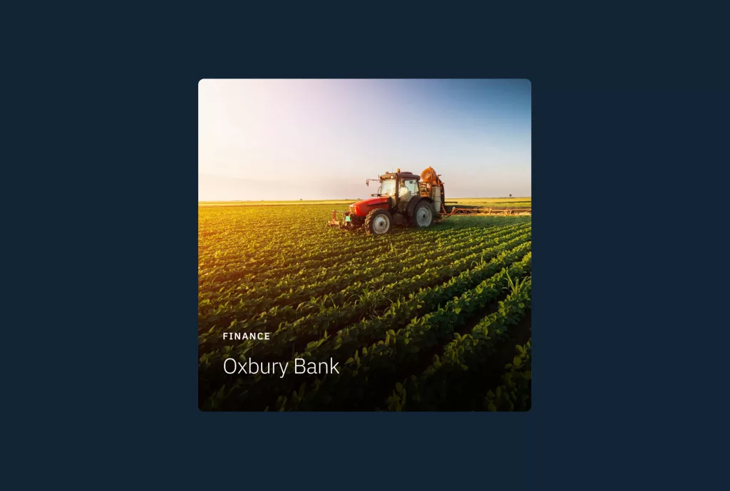 Red tractor spraying rows of green crops across a sunlit field at sunset with overlaid text Oxbury Bank