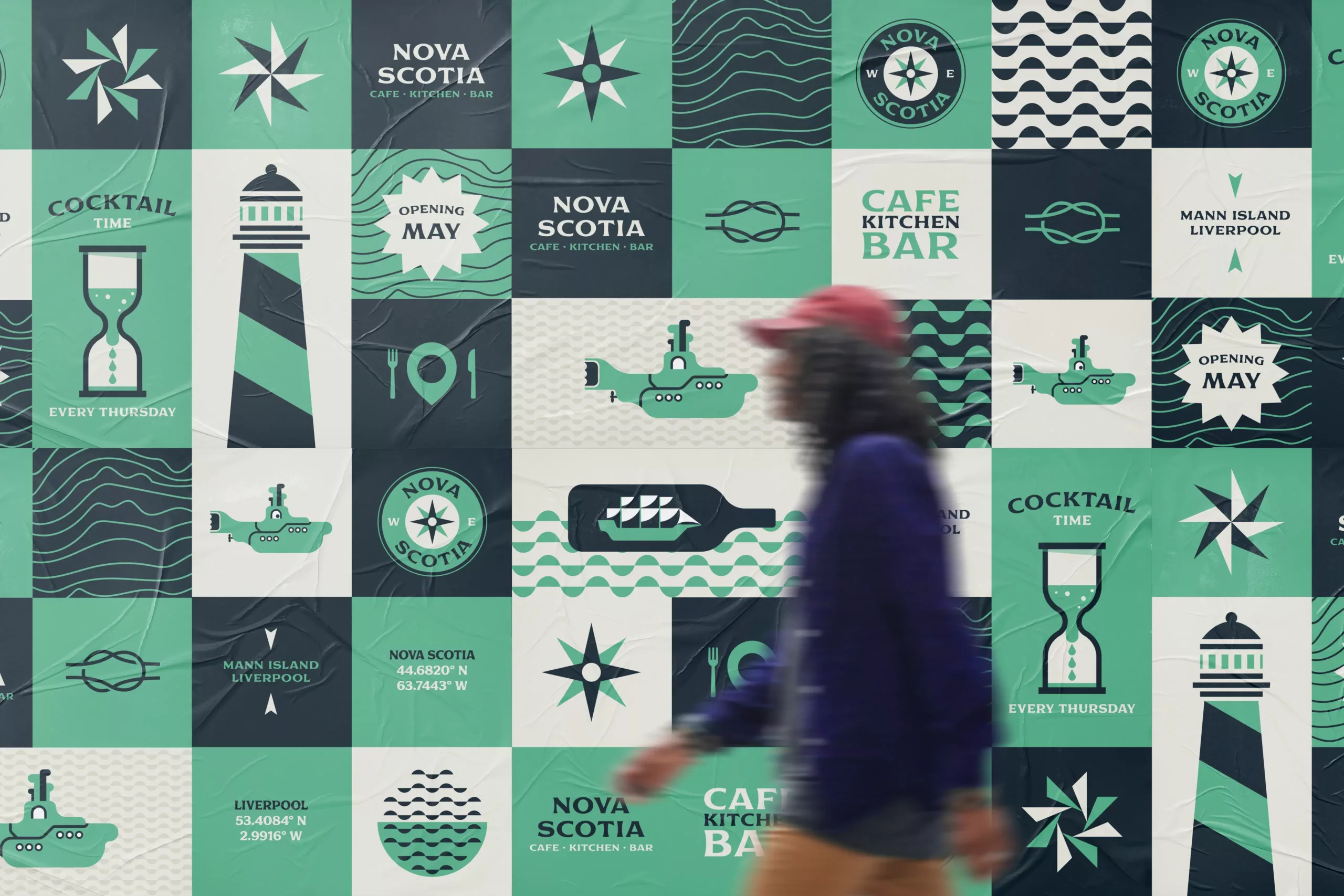 Blurred pedestrian in red cap walks past a tiled mural of teal and navy nautical icons and Nova Scotia branding.