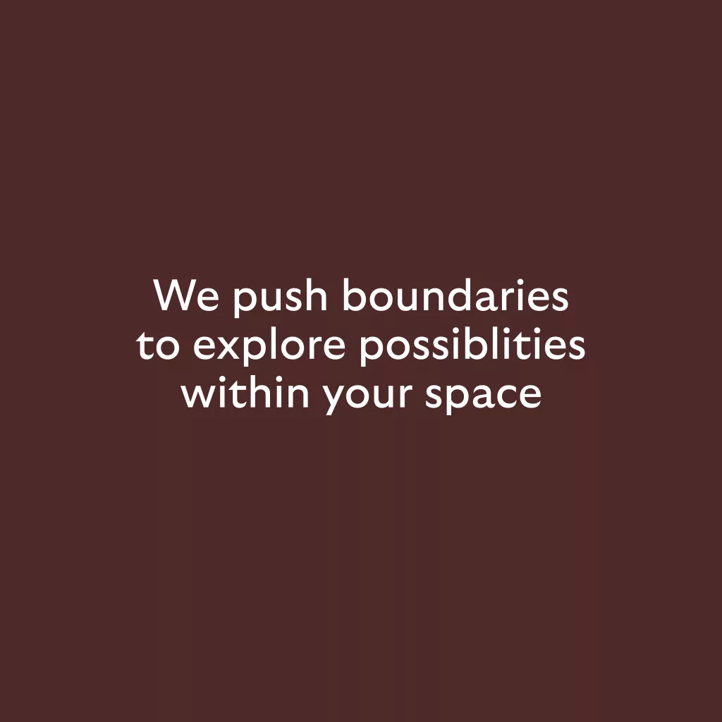 White centred text on a dark maroon background reading We push boundaries to explore possibilities within your space.