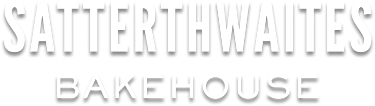 White uppercase logo reading SATTERTHWAITES BAKEHOUSE with a black drop shadow