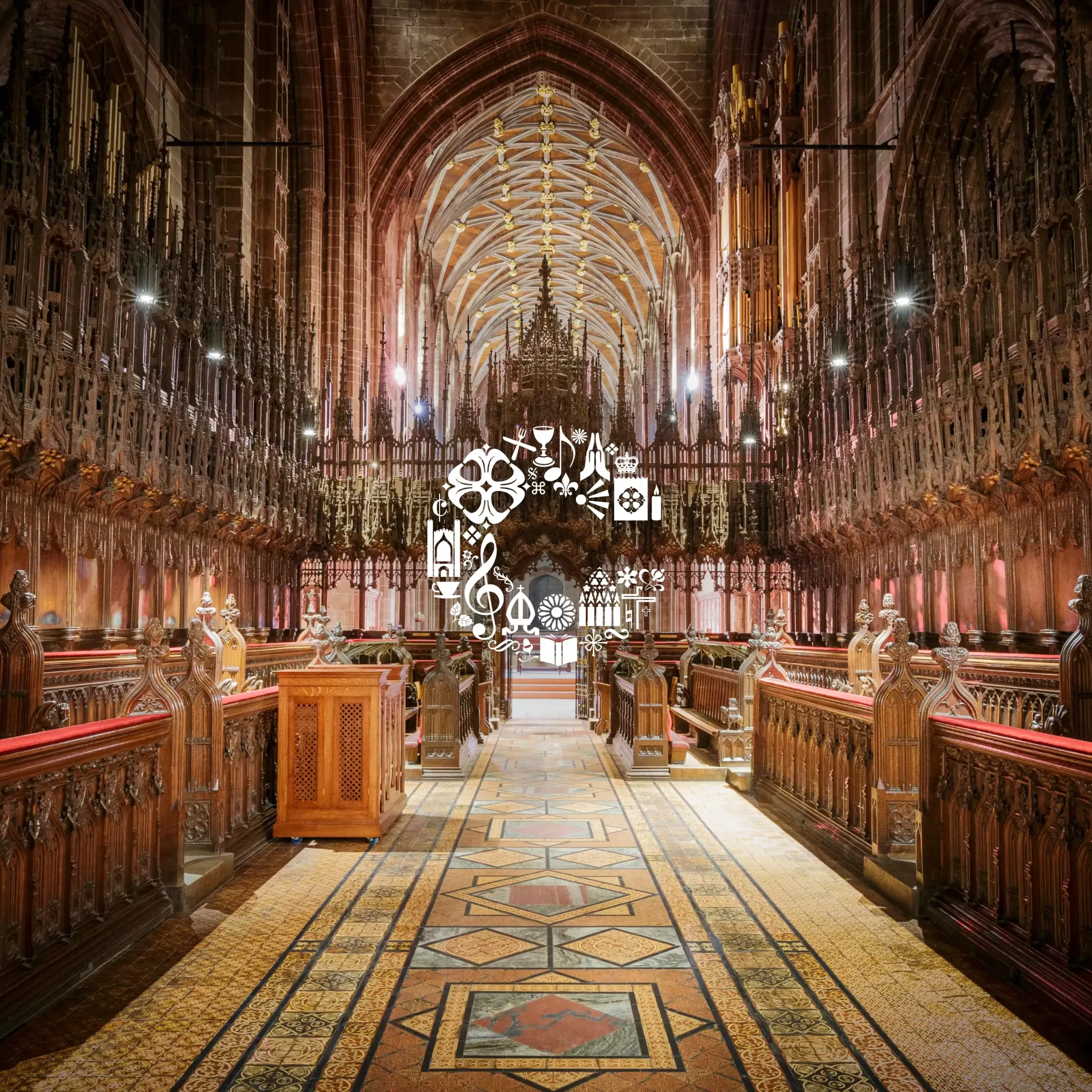 Gothic choir with carved wooden stalls, patterned tiled aisle and ribbed vaulted ceiling, white icon wreath at centre.
