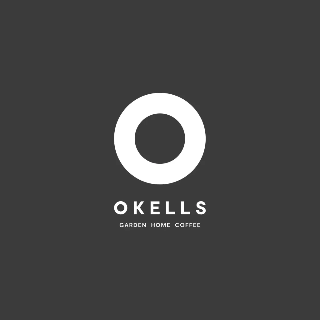 White hollow ring logo above the word OKELLS with smaller Garden Home Coffee text on a dark grey background.