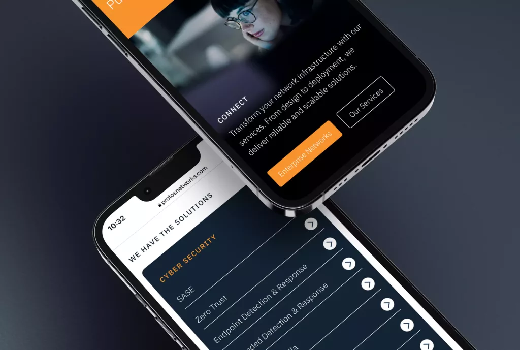 Two angled smartphones overlapping, displaying a dark-themed website with a "Cyber Security" menu, orange CTA buttons and metallic frames.